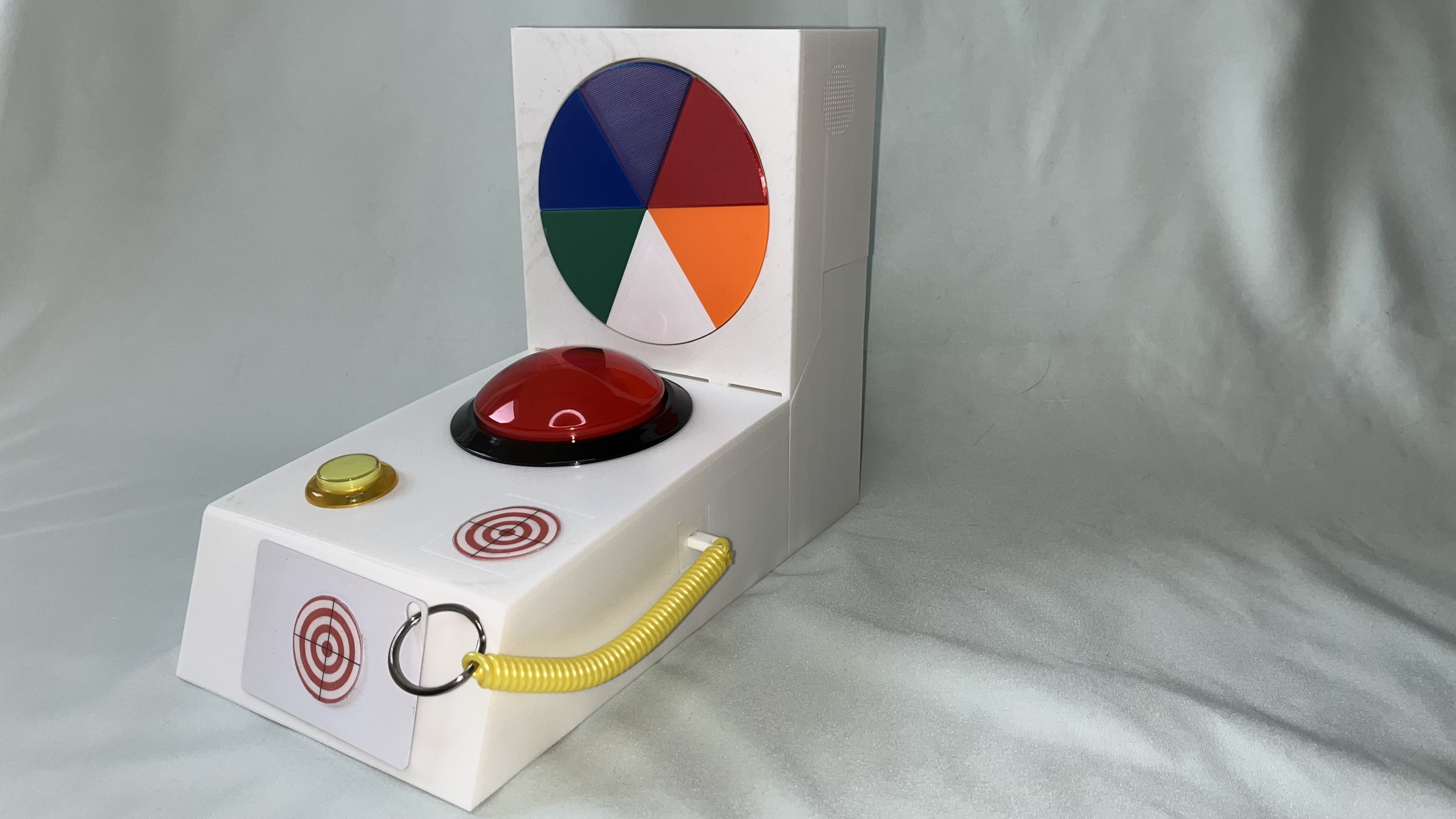 Neuro Stim prototype — tactile arcade game with color wheel display, large dome button, and sensory controls